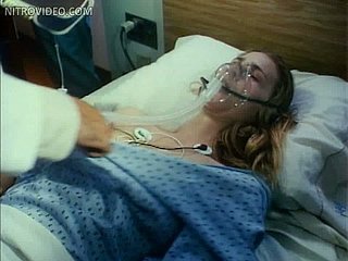 Gorgeous Blonde Babe Kathleen Kinmont Laying Topless On a Hospital Bed